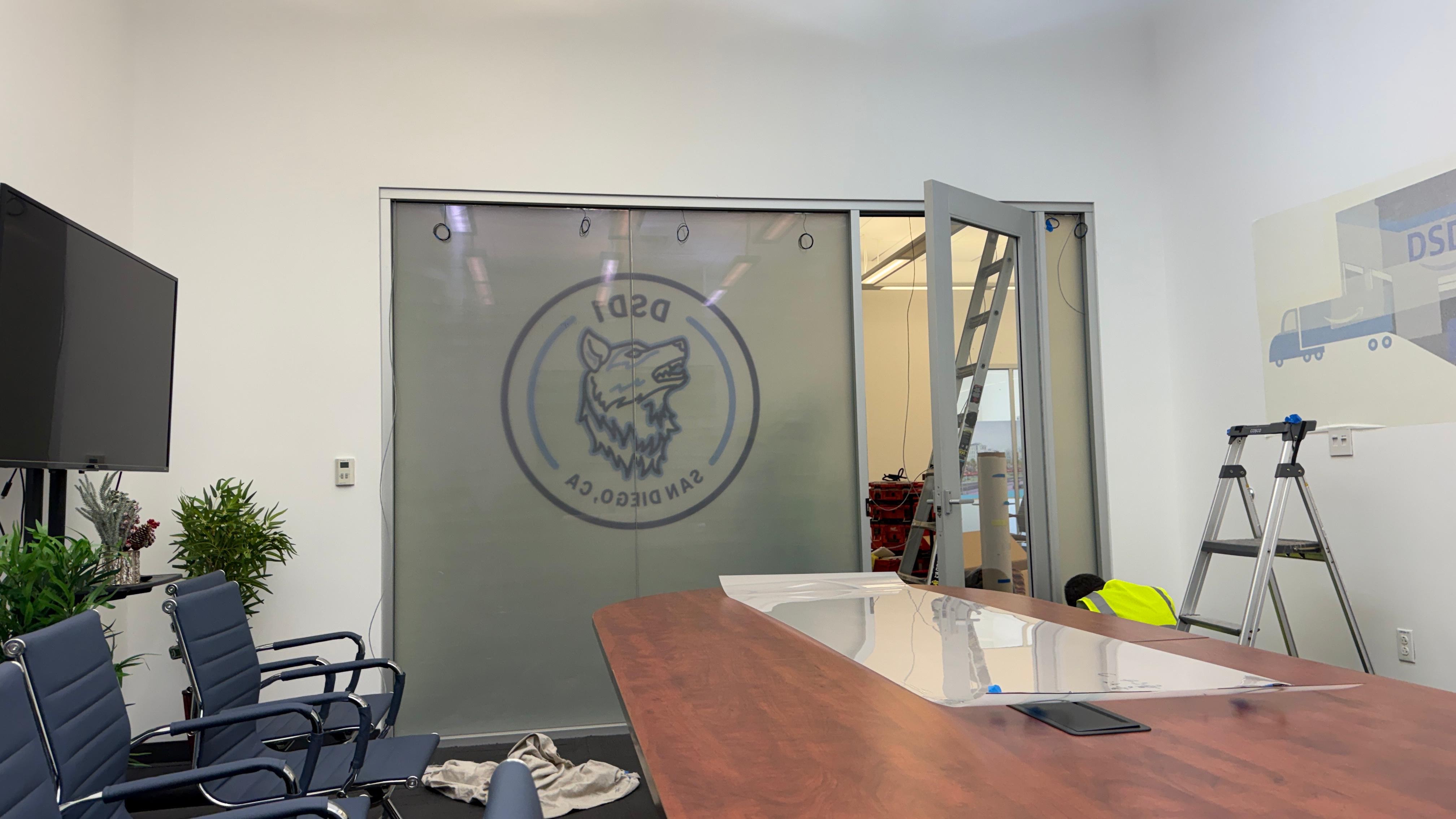 Switchable film troubleshooting — properly installed switchable smart film on a conference room glass partition showing clean activation pattern