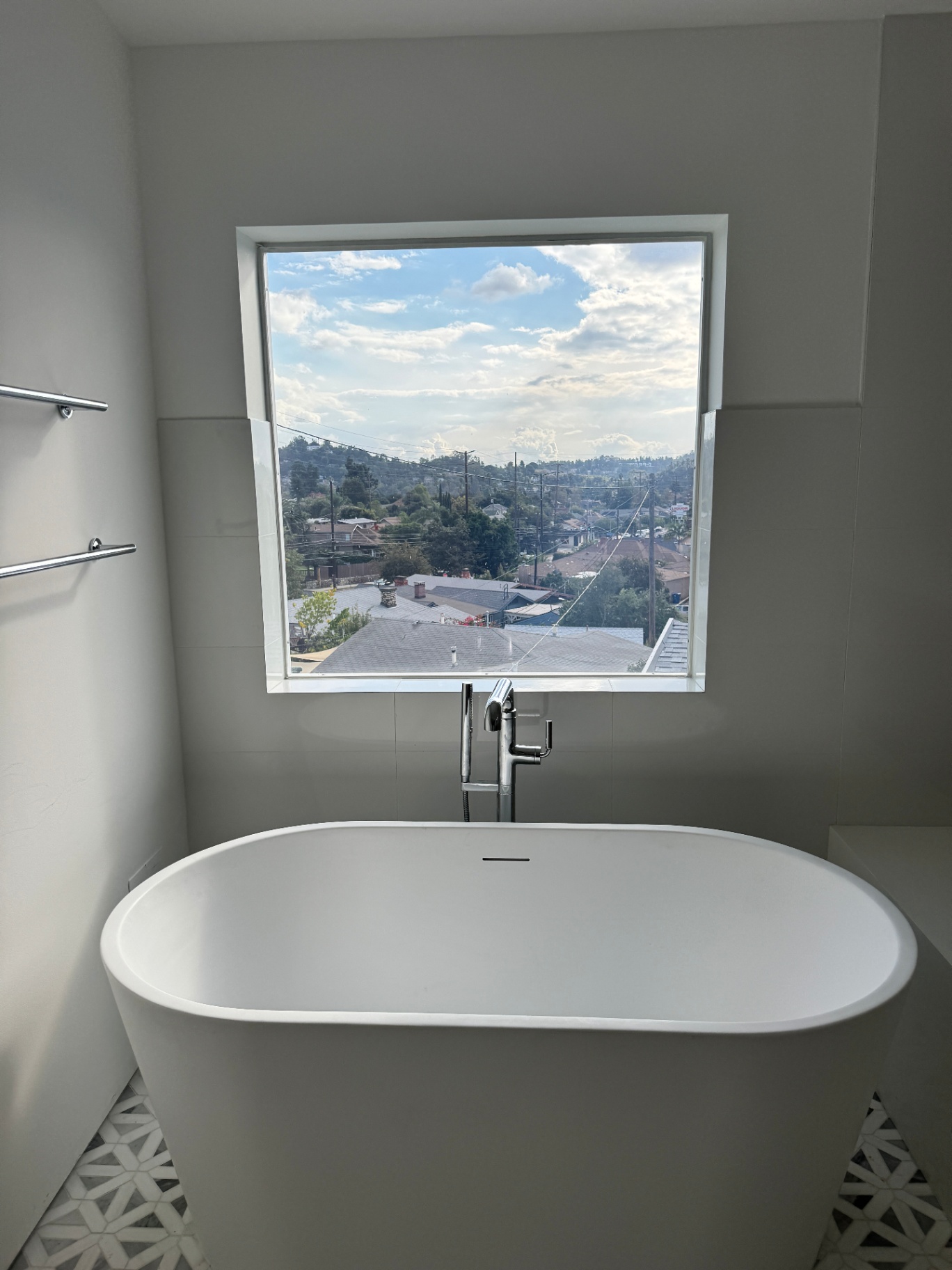 Smart glass home upgrades — modern LA residential bathroom window with switchable PDLC smart film retrofit demonstrating frosted-mode privacy as part of master-bath upgrade spec