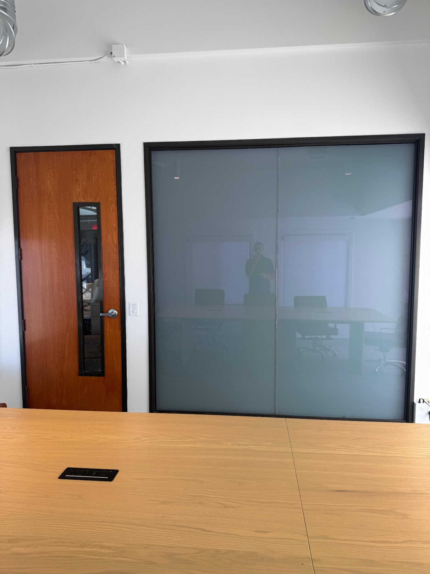 Conference room with smart glass panel demonstrating the fix to common conference room privacy mistakes