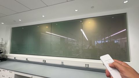 Los Angeles laboratory observation window frosting at the press of a handheld remote